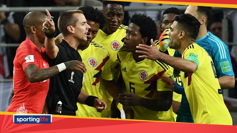 Colombia players argue with the referee