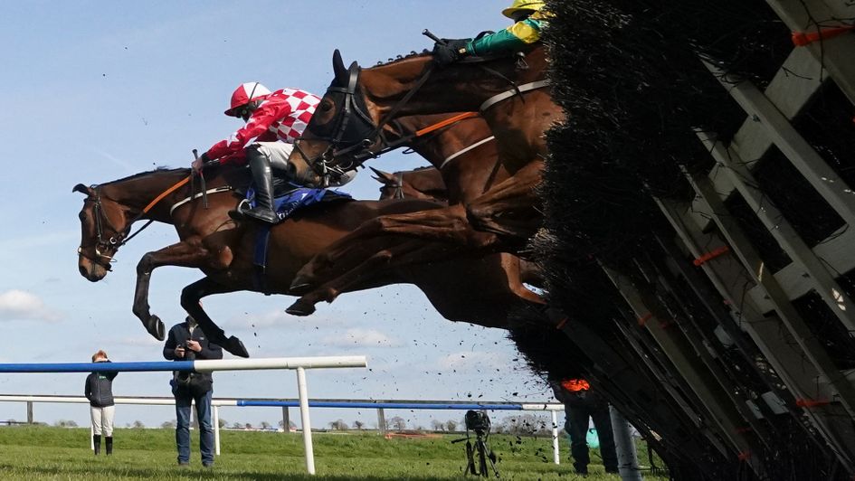 Flame Bearer (red and white check silks) won two Grade 2 novice hurdles