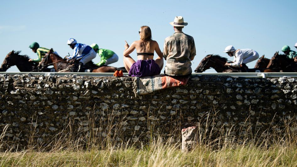 Some sneaky racegoers watch the action at Goodwood