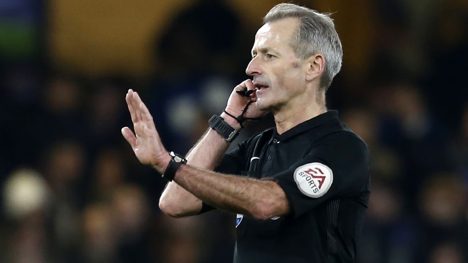 English referee Martin Atkinson stops play to consult with the Video Assistant Referee (VAR)