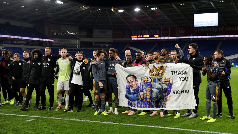 Leicester City team hold up a tribute banner to Vichai Srivaddhanaprabha