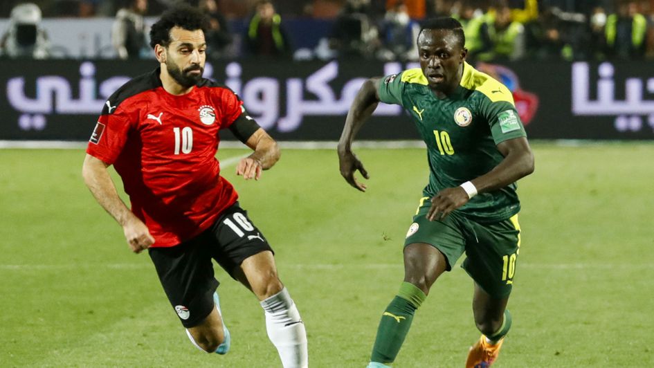 Egypt's Mohamed Salah (L) vies for the ball against Senegal's Sadio Mane