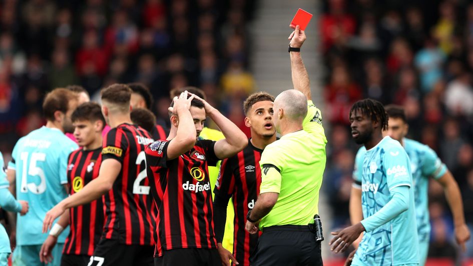 Bournemouth's Lewis Cook is shown a red card by referee Paul Tierney