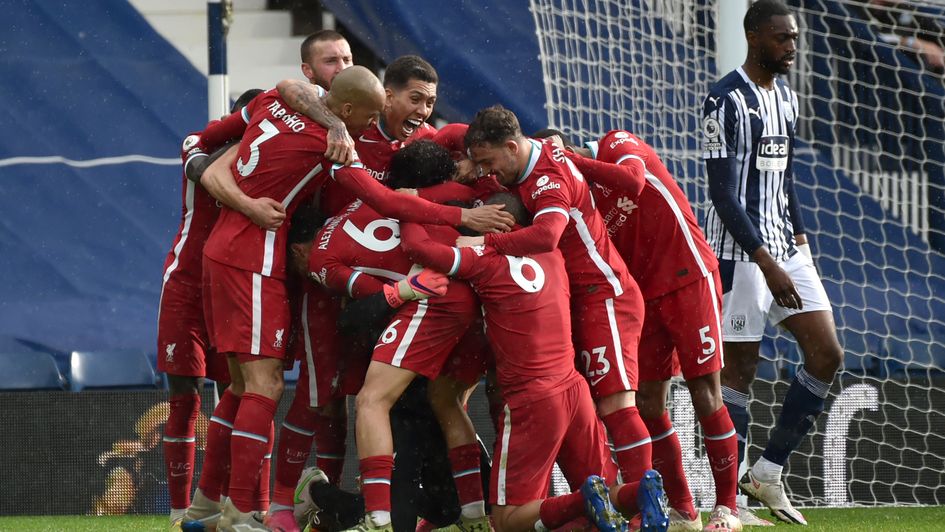 Liverpool goalkeeper Alisson celebrates with team-mates after scoring their side's second goal of the game against West Brom
