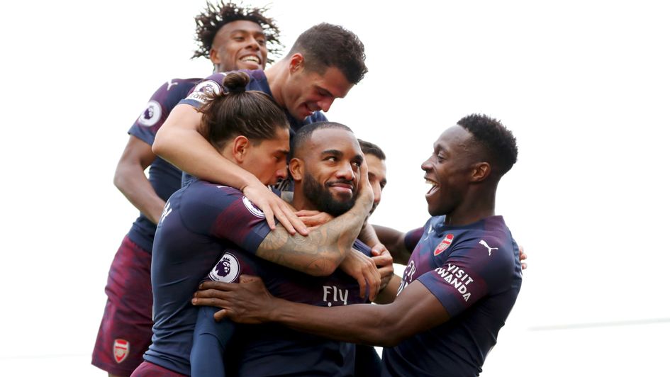 Alexandre Lacazette (centre) and his Arsenal teammates celebrate the Frenchman's goal v Fulham