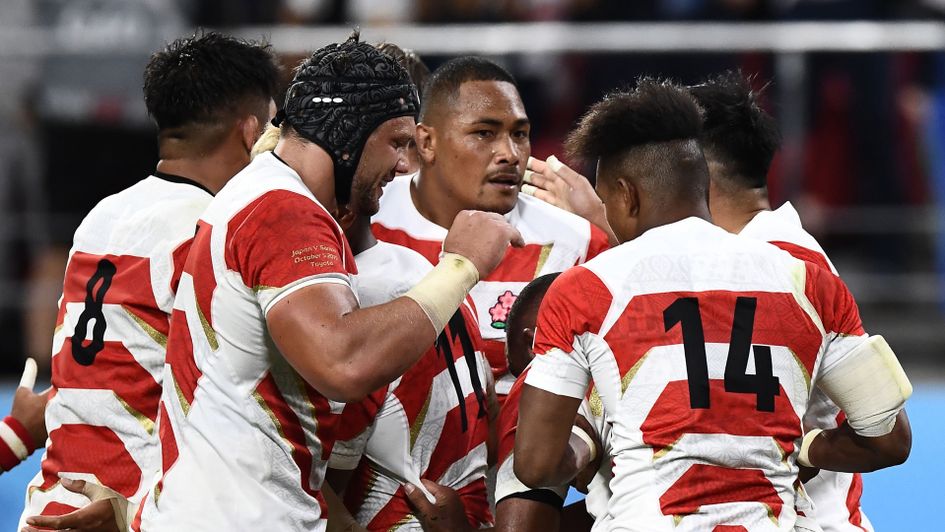 Japan's number 8 Kazuki Himeno (left) celebrates with teammates