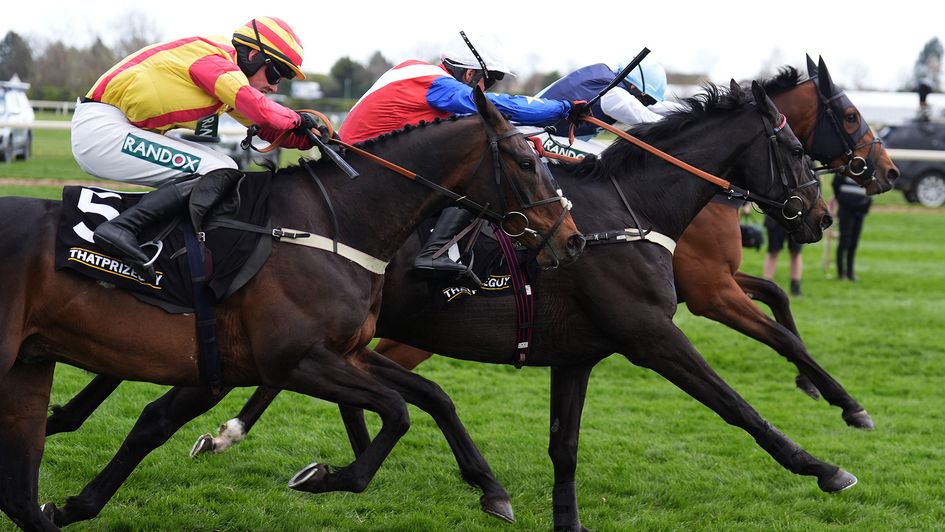 Storming George (nearside) springs a surprise at Aintree