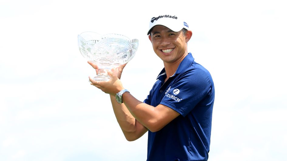 Collin Morikawa of the United States celebrates with the winner's trophy