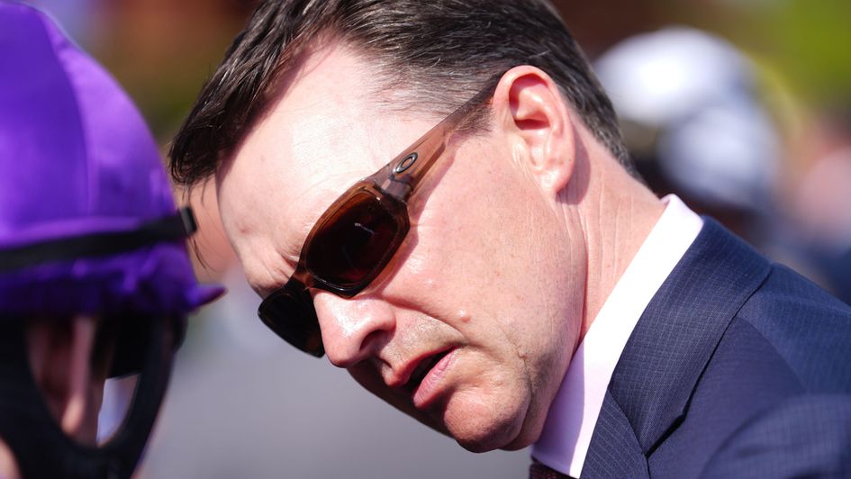 Aidan O'Brien listens to Ryan Moore at Newmarket