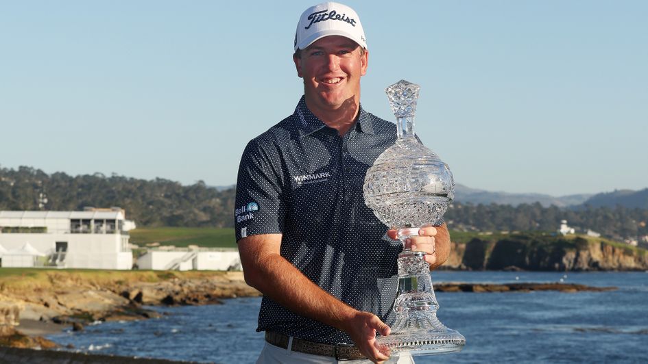 Tom Hoge celebrates with the trophy after winning the AT&T Pebble Beach Pro-Am