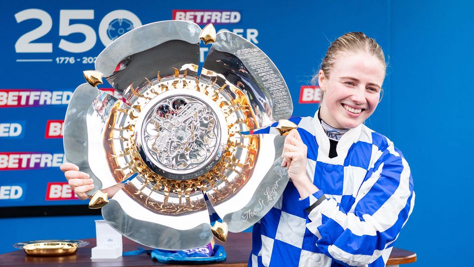 Saffie Osborne celebrates with the Betfred St Leger trophy
