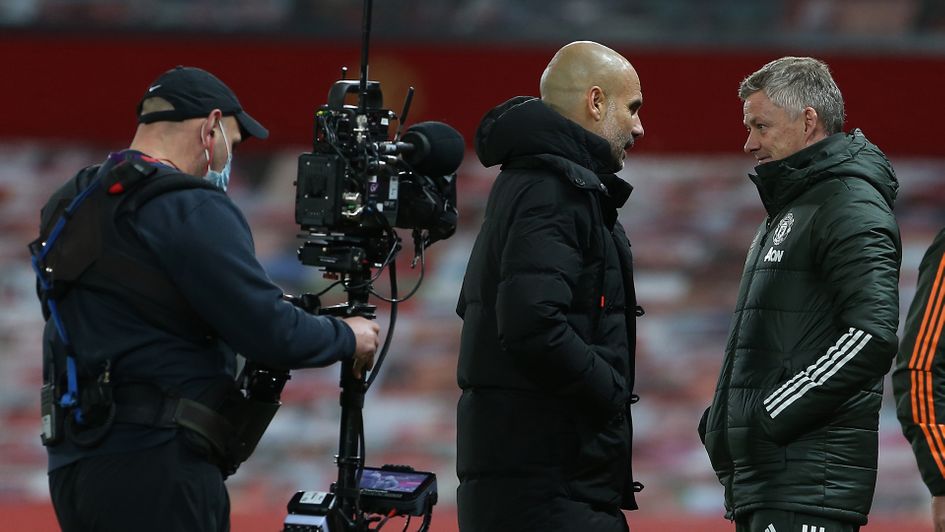 Pep Guardiola in discussion with Ole Gunnar Solskjaer