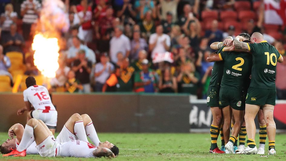 England's players slump to the ground as Australia celebrate