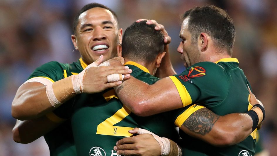 Dane Gagai celebrates with team-mates after his first try