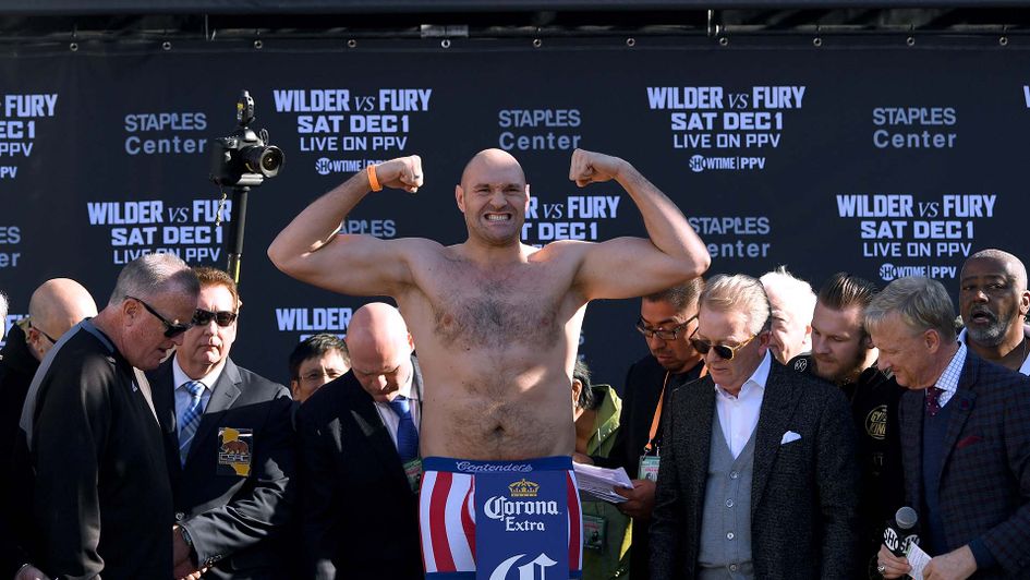 Tyson Fury weighs in for his world heavyweight title clash with Deontay Wilder