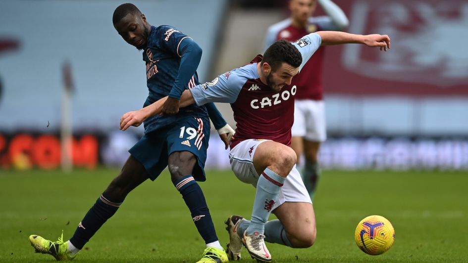 Nicolas Pepe and John McGinn battle for the ball