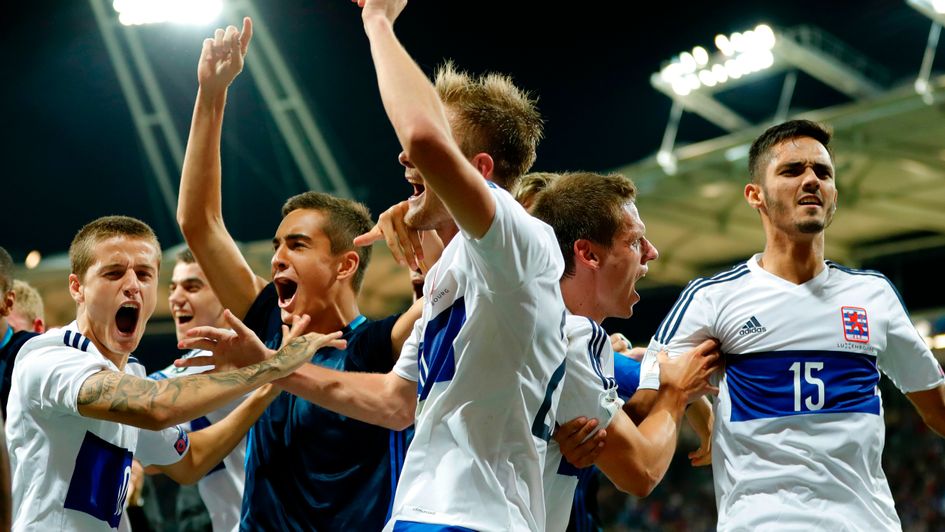 Luxembourg's players celebrate a famous result