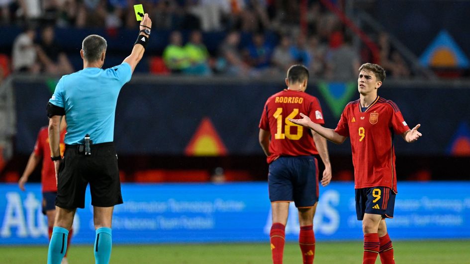 Spain's Gavi receives a yellow card