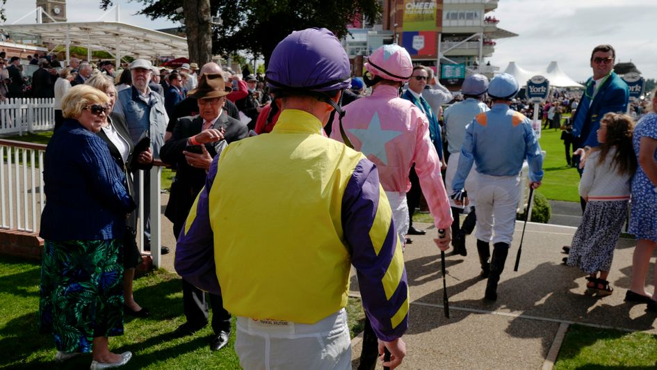 Jockeys head into the parade ring at York