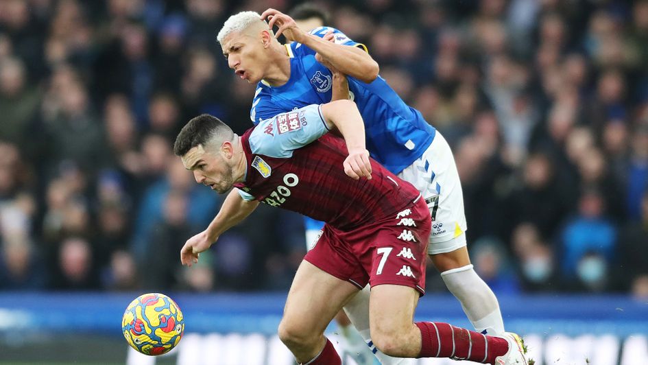 Richarlison battles for possession with John McGinn