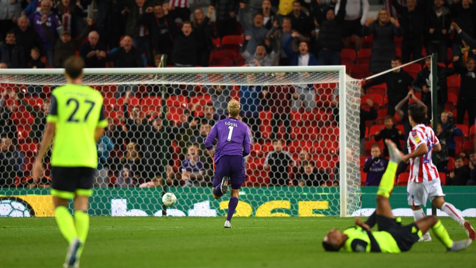 Jonas Lossl tracks back as Juninho Bacuna's mishit rolls into the back of the net