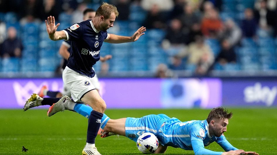 Millwall's Billy Mitchell fouls Coventry City's Josh Eccles at the Den