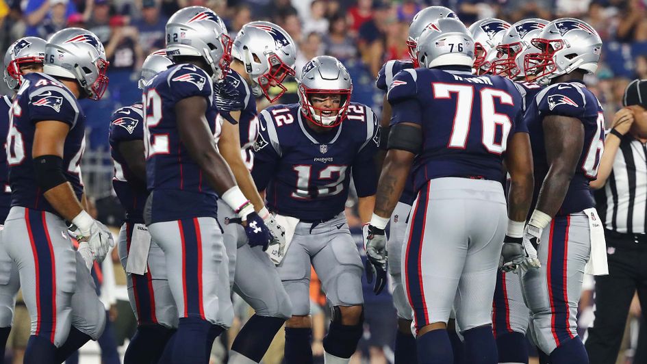 Tom Brady in the huddle with the New England Patriots