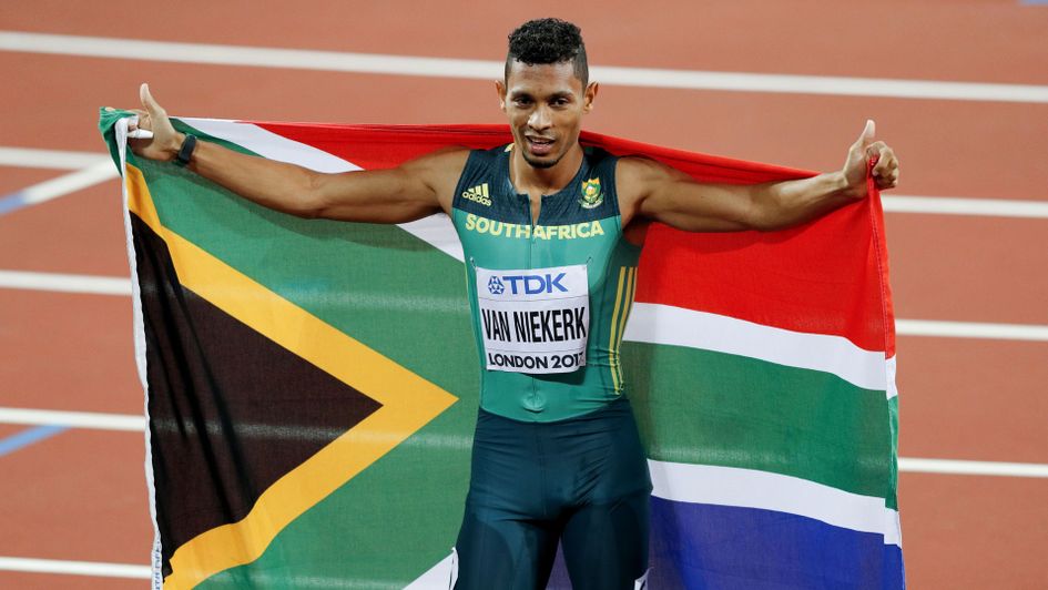 South Africa's Wayde Van Niekerk celebrates with the South African flag