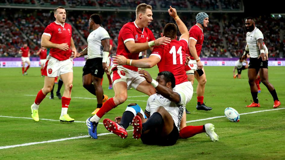Wales' Josh Adams celebrates scoring against Fiji