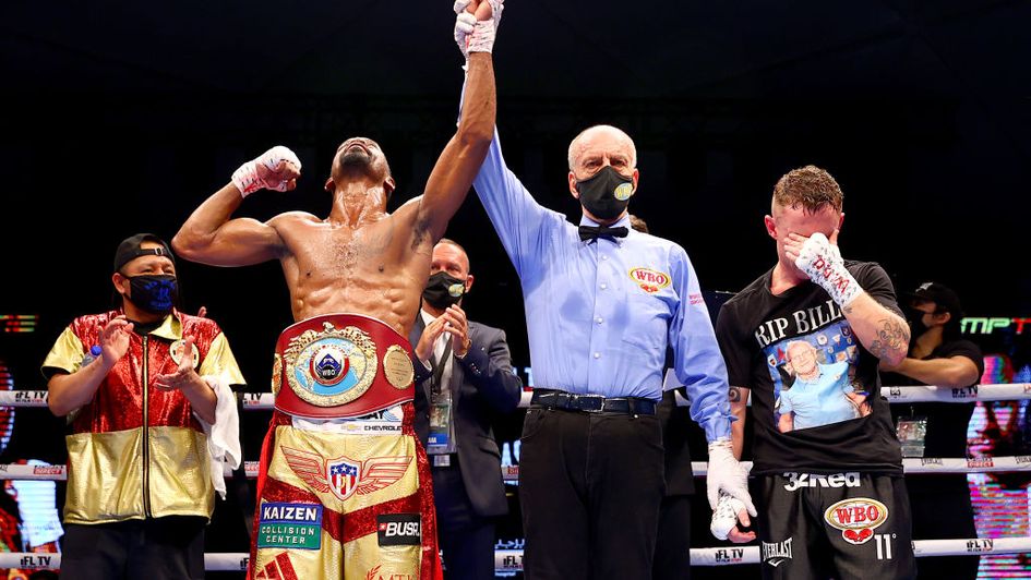An emotional Carl Frampton stands by as Jamel Herring's arm is raised
