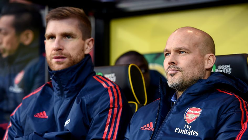 Per Mertesacker (left) and Freddie Ljungberg watch Arsenal in action at Norwich