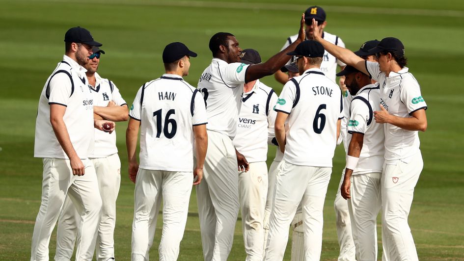 Keith Barker (c) of Warwickshire celebrates with his teammates