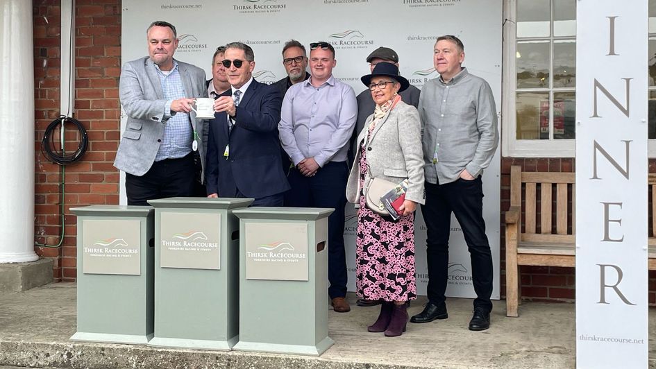 Members of the Sporting Life Racing Club receive the winning trophy