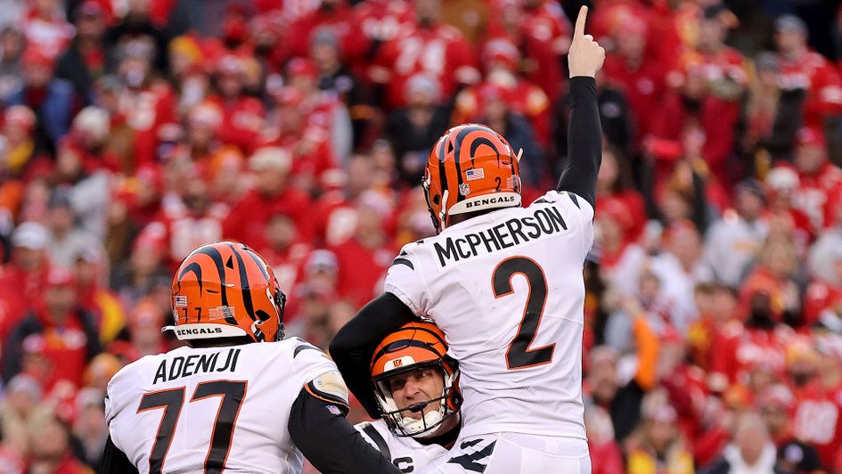 Evan McPherson of the Cincinnati Bengals celebrates with Kevin Huber after hitting the game winning field goal