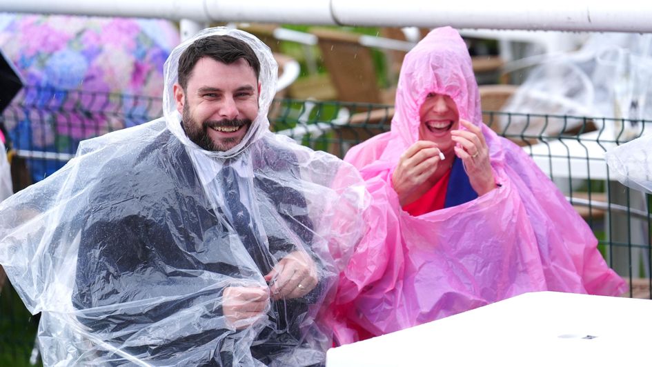 Racegoers in the rain at Doncaster before the Champagne Stakes