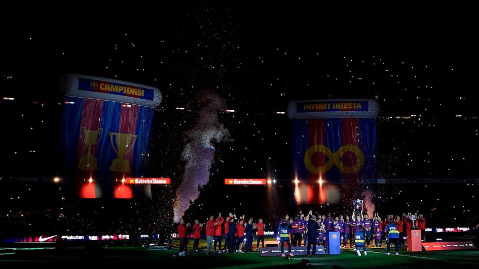 Barcelona celebrate their La Liga win, led by Andres Iniesta