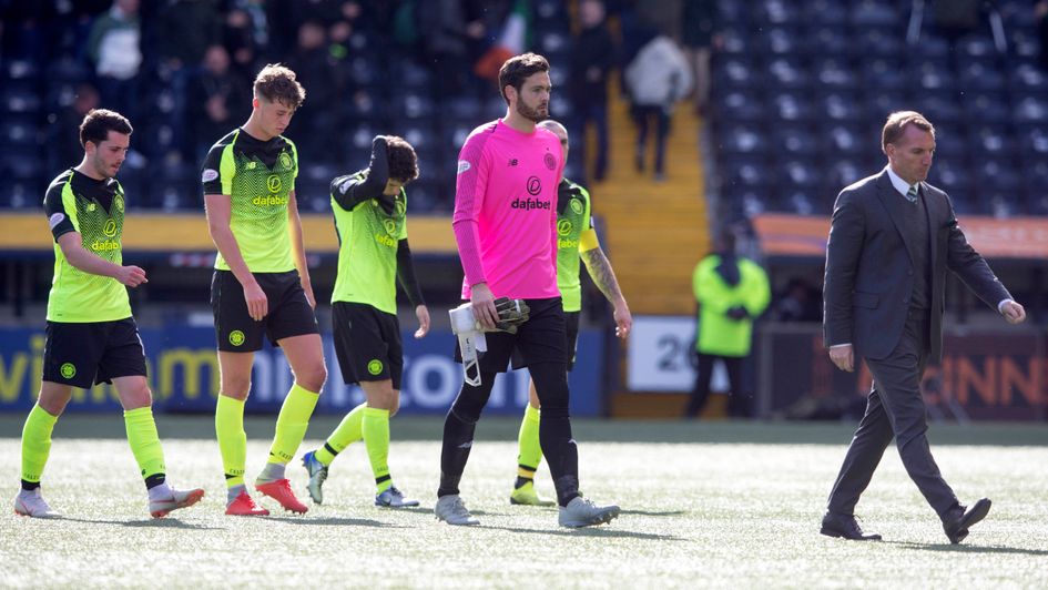 Brendan Rodgers (right) and his Celtic players look dejected after defeat at Kilmarnock