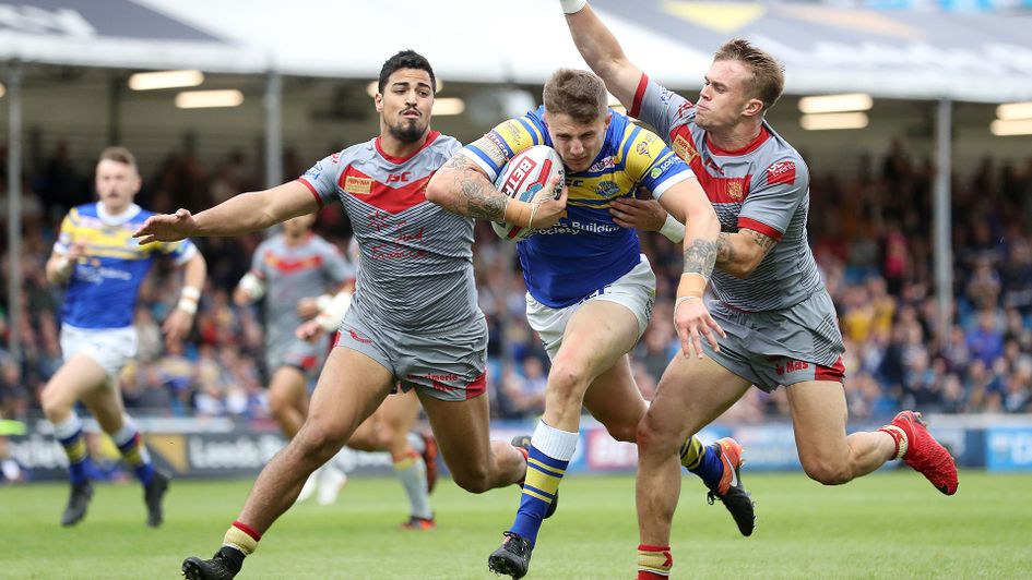 Leeds' Liam Sutcliffe holds off Catalans' Lewis Tierney (right) and Fouad Yaha (left)