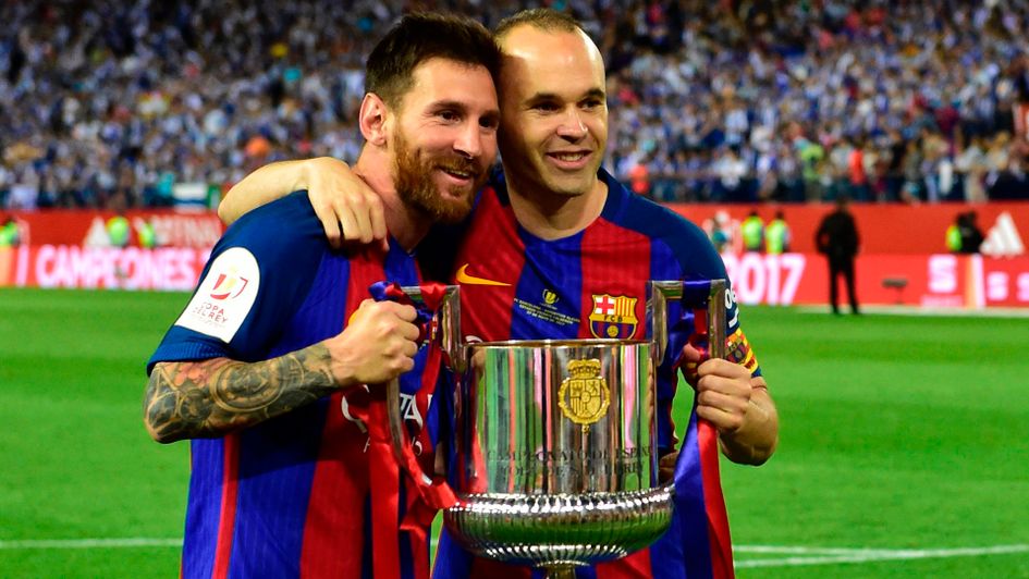 Lionel Messi (l) with the trophy