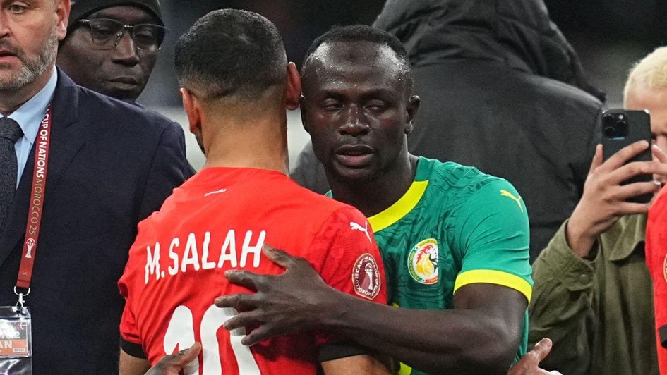 Former Liverpool teammates Sadio Mane and Mohamed Salah embrace after Senegal knocked Egypt out of AFCON