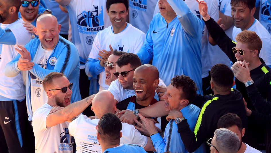 Vincent Kompany is mobbed on stage during the trophy parade in Manchester