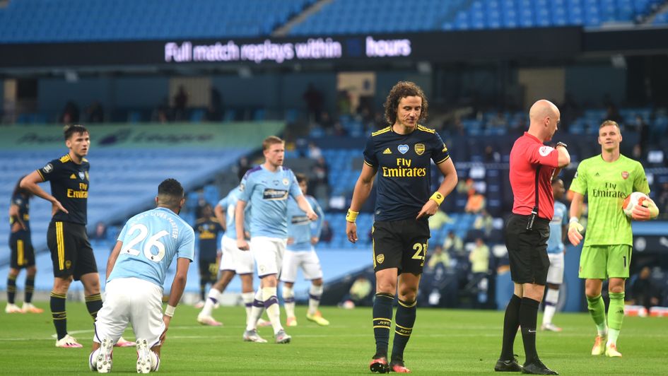 Referee Anthony Taylor sends off Arsenal's David Luiz against Manchester City