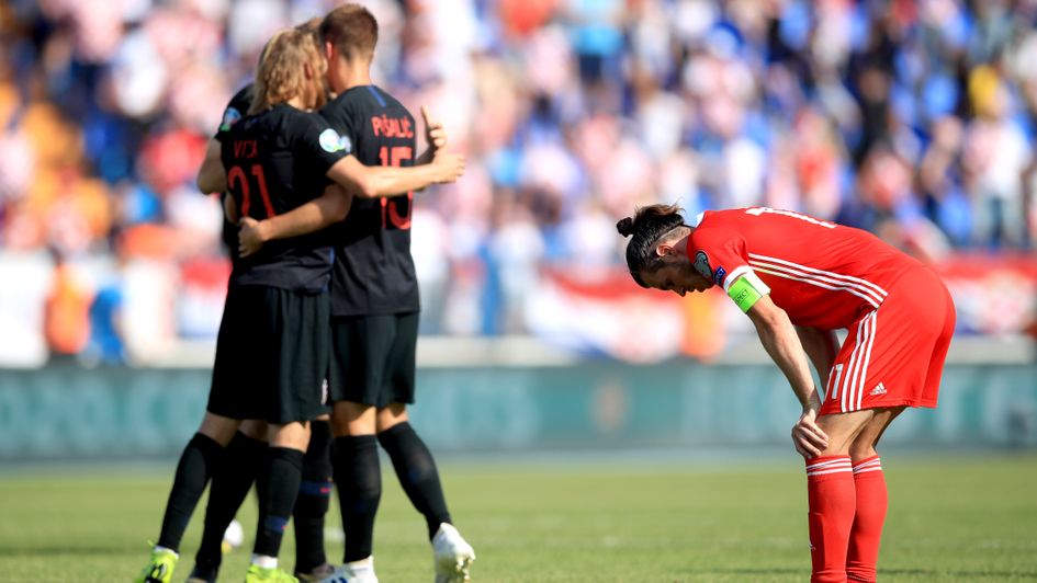 Gareth Bale looks dejected as Croatia celebrate during their win over Wales