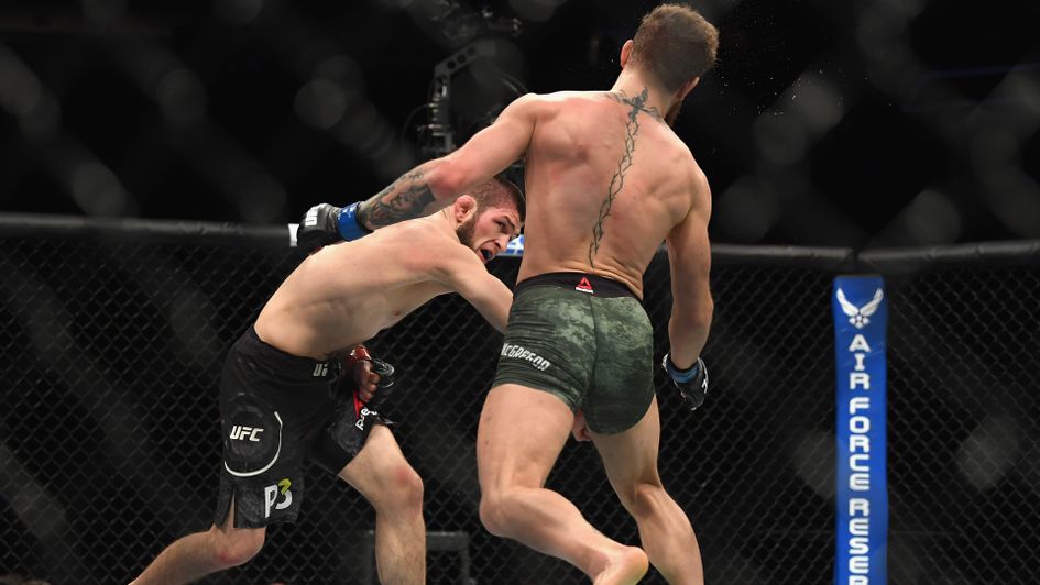 Khabib Nurmagomedov of Russia (L) punches Conor McGregor