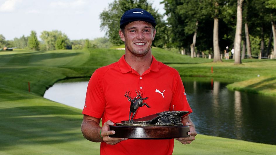 Bryson DeChambeau poses with the John Deere Classic trophy