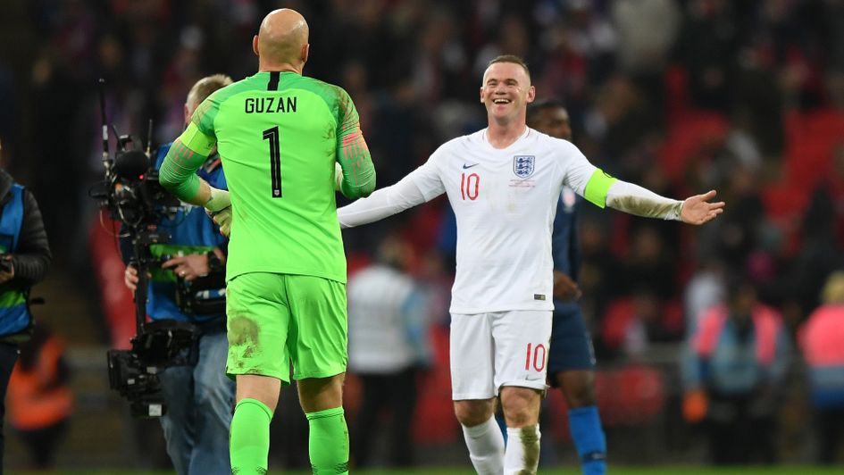 Wayne Rooney shares a joke with Brad Guzan