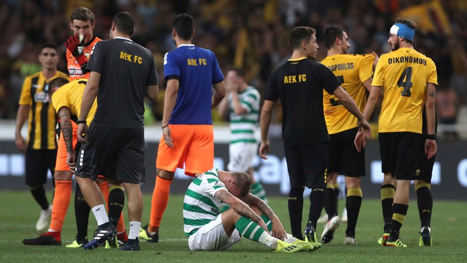 Celtic's Leigh Griffiths sits on the pitch after his team were dumped out of the Champions League by AEK Athens