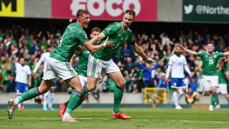 Jonny Evans of Northern Ireland celebrates with Daniel Ballard