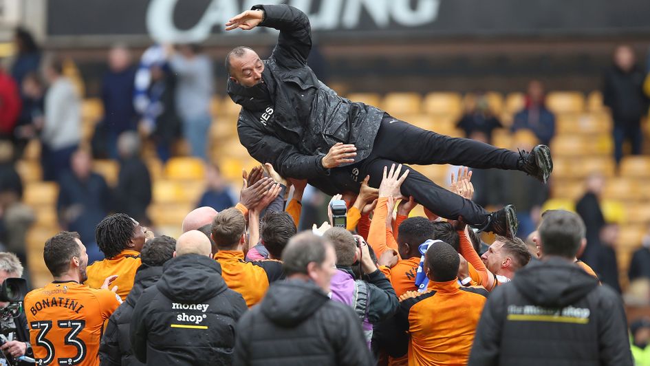 Wolves players throw manager Nuno Espirito Santo up in the air as they celebrate promotion