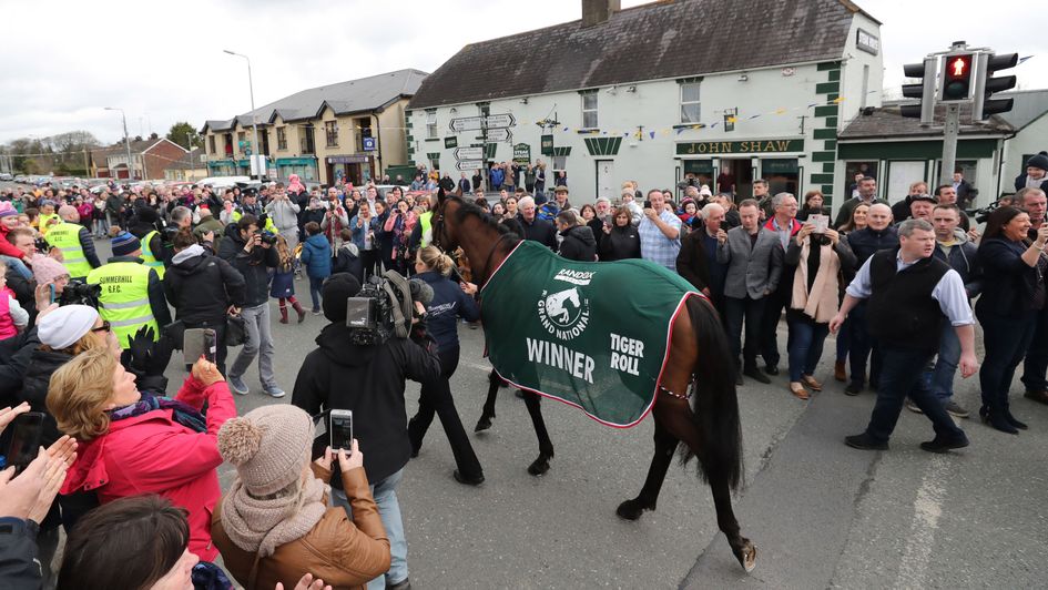 Fans take pictures of National hero Tiger Roll